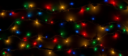 color lights of a garland on black background