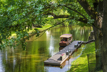 wood boat on the city river in the central park of Riga, Latvia.