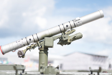 Single missile anti tank launcher against clear blue sky.