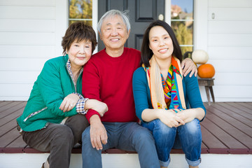 Happy Chinese Senior Adult Mother and Father with Young Adult Daughter