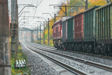 Railroad going along the colorful forest in Autumn. Leaves have changed colors and creates a wonderful Autumn scenery along the Railway infrastructure.