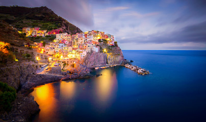 View of the city and port of Manarola, one of the Cinque Terre, a beautiful gem and famous destination in the Mediterranean sea - 180036906