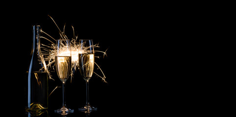 Bottle and two glasses of champagne in Bengal lights © alexlukin