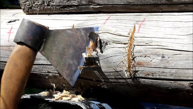 Assembling a wooden frame and building a house. Russia. Texture of old wooden logs, recess in the log for joining for using ax.