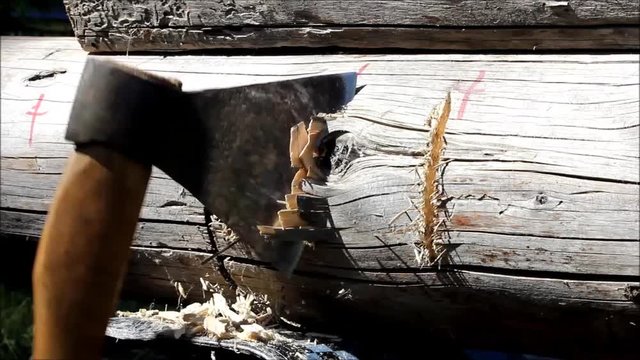 Assembling a wooden frame and building a house. Russia. Texture of old wooden logs, recess in the log for joining for using ax.