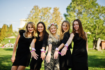 Five girls wear on black having fun at hen party.