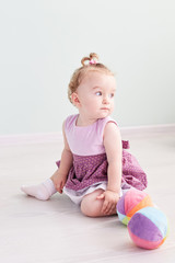 little child is playing with toys in the studio