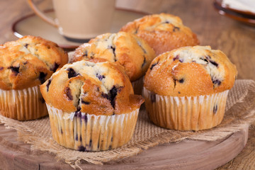Golden Brown Blueberry Muffins on a Wooden Platter