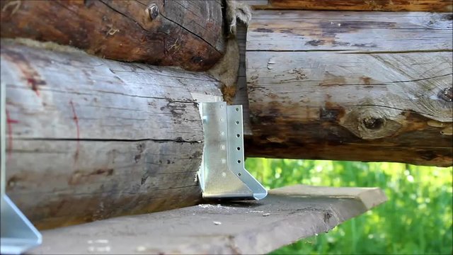 Assembling a wooden frame and building a house. Russia. Several metal fixings for the construction of a floor in a wooden house.