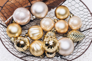 Fototapeta na wymiar Close-up photo of round golden Christmas toys on the ground. Christmas and New Year concept