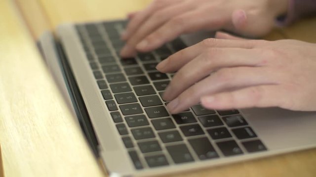 Closeup Footage Of Woman Typing On Laptop At Wooden Table