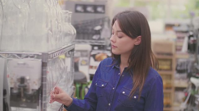 Beautiful Young Woman Buying Glass In Shop