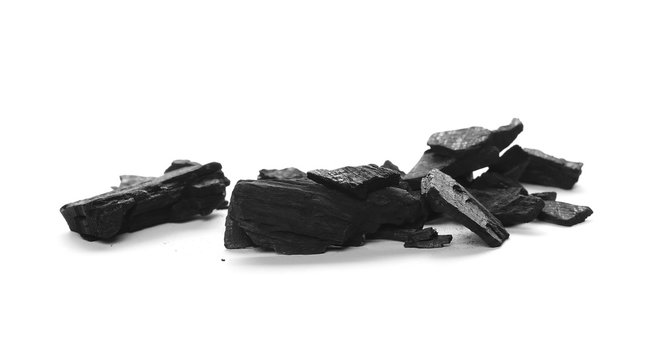 Pile black charcoal isolated on white background
