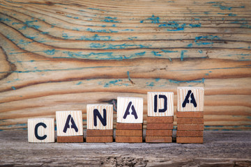 Canada. Wooden letters on the office desk, informative and communication background.