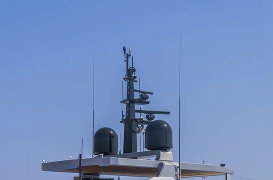 Nautical radio radar and antena at luxury yacht docked at marina