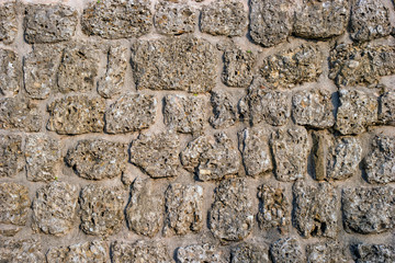 Wall of stone. Stones of different shapes. Suitable for background.