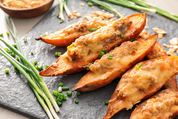 Yummy stuffed sweet potato on kitchen table