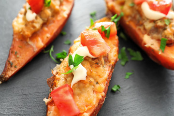 Slate plate with yummy stuffed sweet potato, closeup