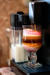 Cooking naturally delicious coffee with syrup in automatic coffee machine in the morning