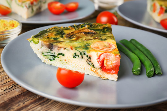 Plate with delicious spinach frittata on table