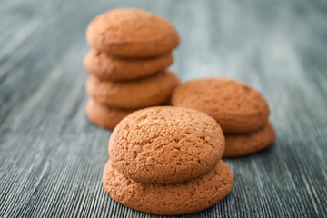 Tasty oatmeal cookies on wooden table