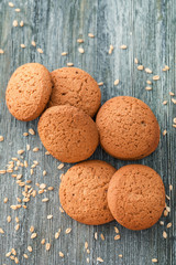 Tasty oatmeal cookies on wooden table