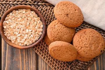 Tasty oatmeal cookies on table