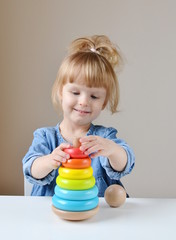 Adorable Little Caucasian Girl Playing with Wooden Colorful Toy Pyramid at Home Playroom Happy 