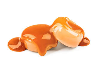 Sweet candies with caramel topping on white background