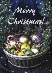 A large basket of fruit and Christmas balls. Crowned wreath of spruce branches. It is on the table.