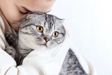 Young beautiful woman with fluffy cat at home