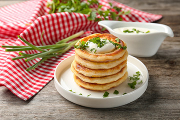 Plate with Hanukkah potato pancakes on table