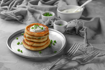 Metal plate with Hanukkah potato pancakes on table