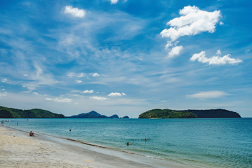 Tourists have a rest and swim at Pantai Tengah Beach, Langkawi Island, Malaysia. People relaxing on paradise beach