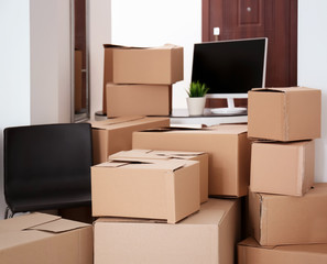 Carton boxes with stuff in room. Office move concept