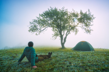 Fototapeta premium Man sitting on a frozen meadow