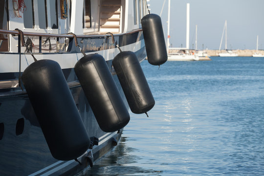 Fototapeta Black rubber inflatable ship fenders