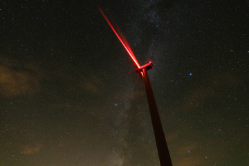 wind turbines generating clean power with milky way