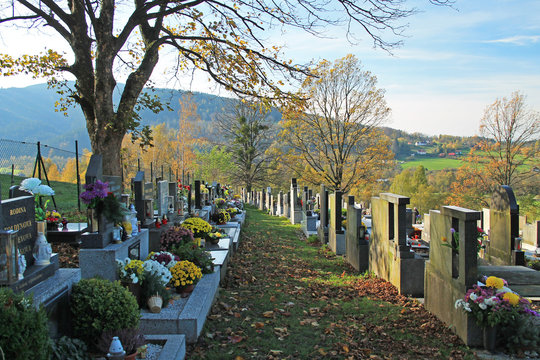 various decorated graves on the cemetery and some trees in autumn, Prazmo, Czech Republic