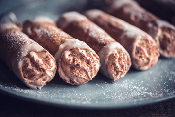 Close up to sweet homemade cannoli with chocolate and vanilla cream,selective focus