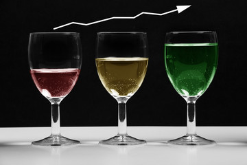 Glasses with colored water growing business chart.