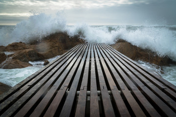 Wooden pier on a stormy ocean