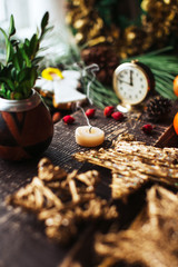Christmas background with decorations and candles, candle on fire with woman hand
