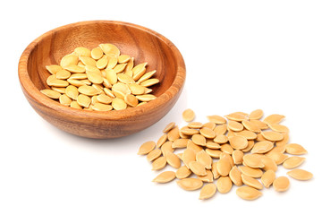 Pumpkin seeds in bowl closeup.