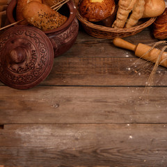 Bakery products and rolling pin on a wooden table. Rustic concept. Top view. Copy space