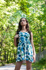 Fototapeta premium Girl tourist is standing in the forest