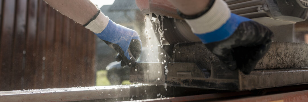 Low angle view of an angle grinder or circular saw cutting a concrete block