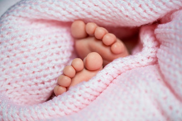 little legs baby in a grey scarf