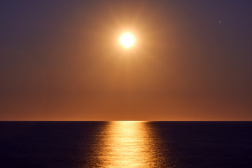 The rising of the full moon over the sea