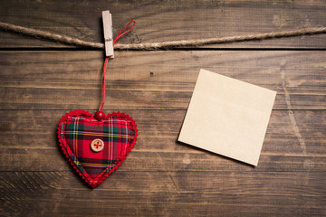 Heart decoration hanging on a rope and a paper note